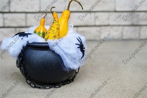 Halloween holiday background. Witch's cauldron with pumpkins