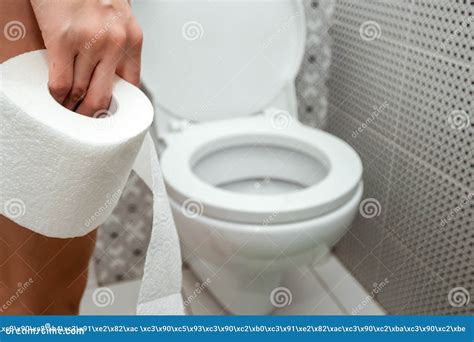 Close Up Hands Duvushki Holding A Roll Of Toilet Paper In Front Of