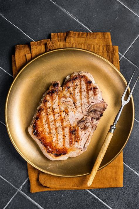 Bbq Fried Pork T Bone Chop Meat Steak On A Plate Black Background