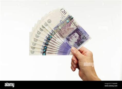 Fan Of Twenty Pound Notes With Hand Stock Photo Alamy