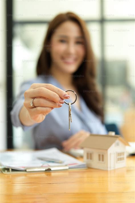 Focused Hands Beautiful Real Estate Agent Holding House Key House Model And Rental Contract On