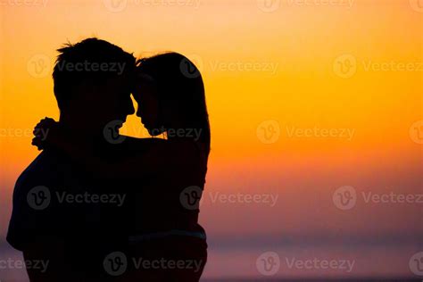 Family silhouette in the sunset at the beach 17753503 Stock Photo at Vecteezy