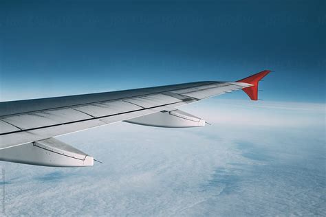 Airplane Wing During A Flight Over A Sky With Clouds Del Colaborador