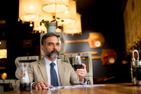 Premium Photo Handsome Mature Man Drinking Glass Of Red Wine In Restaurant