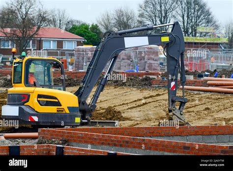 Excavator Working On New Residential Housing Development Construction