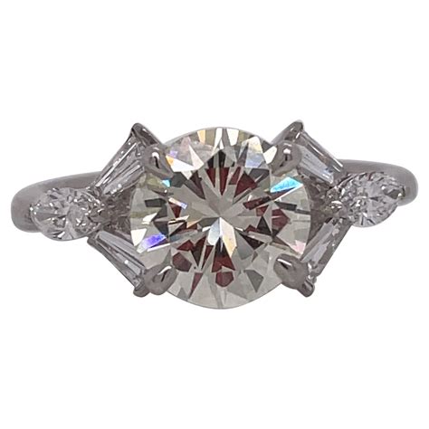 Classic Round Diamond Engagement Ring With Tapered Baguettes For Sale