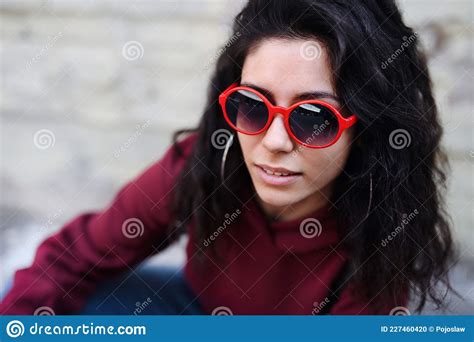 Close Up Portrait Of Young Woman With Sunglasses Standing Outdoors On Street In City Stock