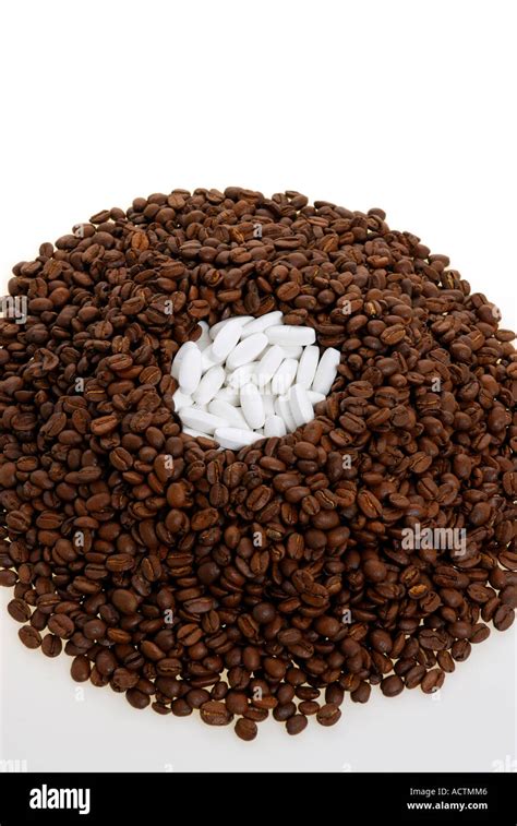 A volcano of coffee beans and white pills Stock Photo - Alamy