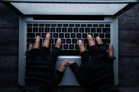 Premium Photo High Angle View Of Hacker Stealing Data From Laptop