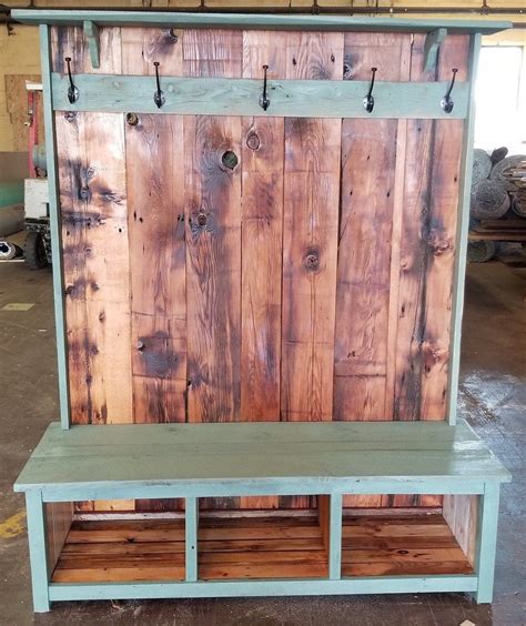 A Bench Made Out Of Wooden Boards With Hooks On The Top And Bottom Shelfs