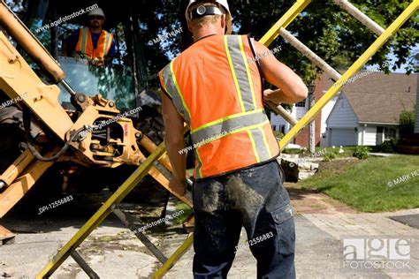 Two construction workers with heavy equipment, Stock Photo, Picture And ...