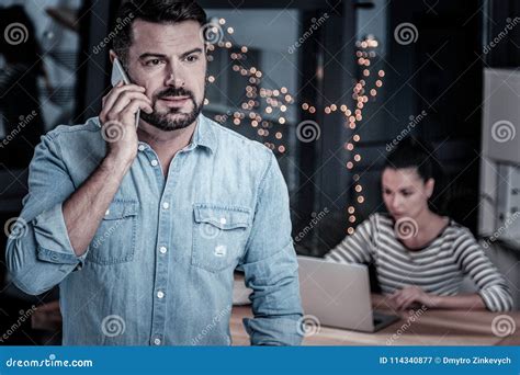 Concentrated Confident Man Looking Aside And Having Phone Conversation