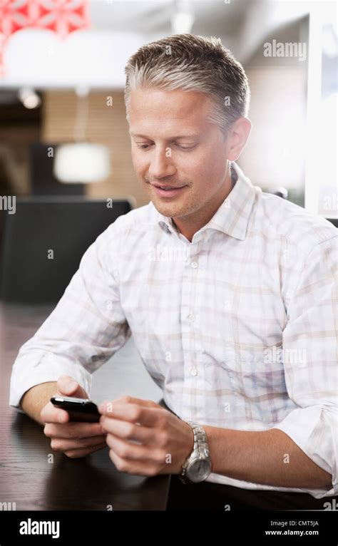 Business Man Sending Text Message Through Cell Phone Stock Photo Alamy