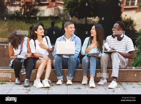 College Students Sitting On Bench