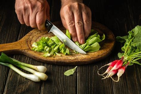 Premium Photo Make Lettuce And Radish Salad At Home Cutting With A