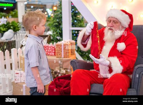 Santa Claus talking and playing surprise games with kids in Shopping ...