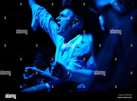 Fans Lit By Stage Lights Watching A Music Festival In East Sussex