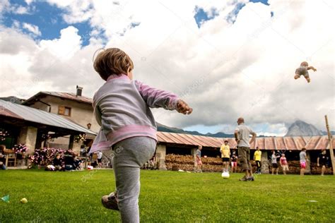 Baby Throwing A Doll In The Air At A Park Outdoor — Stock Photo
