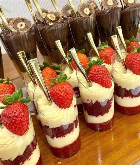 Desserts With Strawberries Are Arranged On A Wooden Table And Lined Up