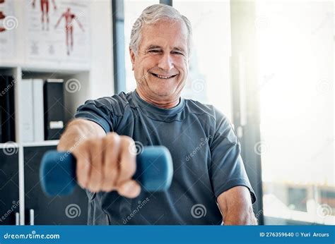 Fitness Is A Good Feeling An Elderly Man Working Out With Weights At A Rehabilitation Center