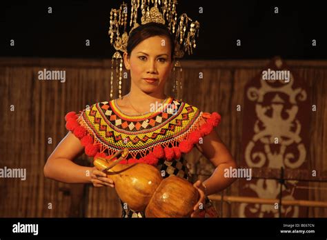 Dancer In Traditional Costume In The Sarawak Cultural Village Near