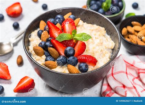 Oatmeal Porridge with Fresh Berries and Nuts. Stock Image - Image of ...