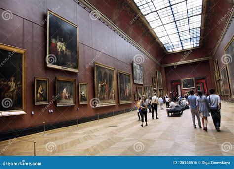 People Walk Through The Hall Of The Art Gallery In The Louvre P