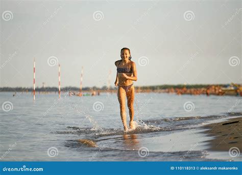 Water Fun The Girl Runs Along The Seashore Stock Image Image Of