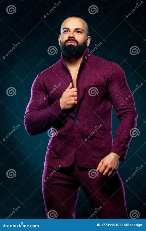 Portrait Of Handsome Stylish Bearded Man Bodybuilder In Red Suit Stock