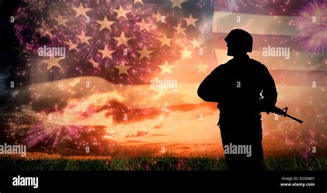 Composition Of Silhouette Of Soldier Against Sunset Sky And Billowing