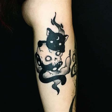 A Black And White Cat Tattoo On The Arm