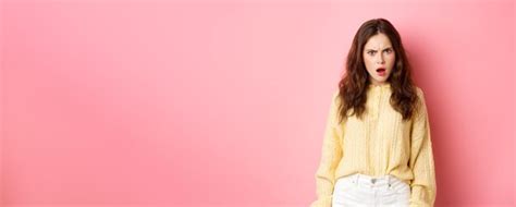 Premium AI Image Shocked And Confused Brunette Woman Gasping Frowning