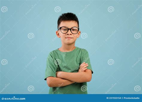 Portrait Of Smiling Little Asian Boy Wearing Eyeglasses Standing With