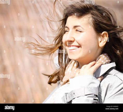 Portrait Of A Smiling Brunette In Windy Day Stock Photo Alamy