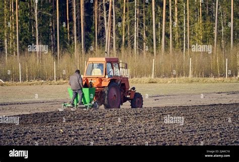 The Tractor Plows The Field Cultivates The Soil For Sowing Grain