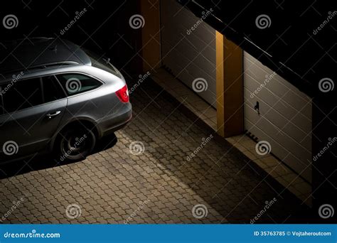 Night View Of A Car Parked In Front Of The Garage Stock Image Image