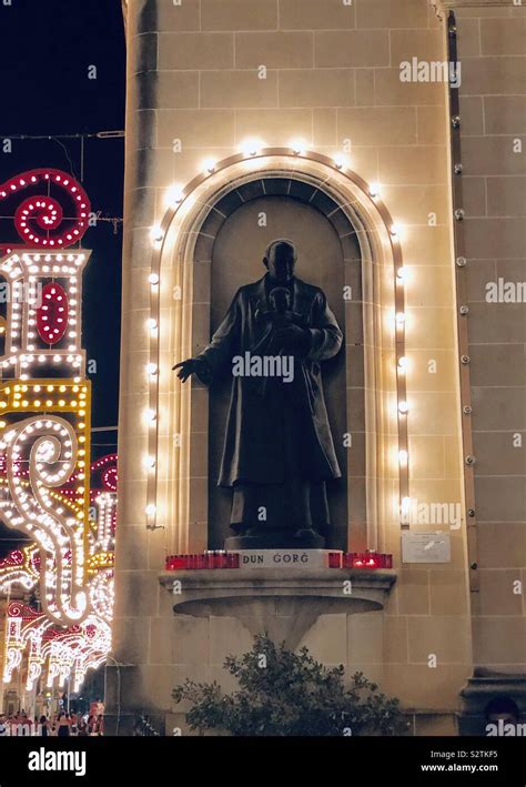 Religious Statue Surrounded By Lights In Victoria Gozo Stock Photo Alamy