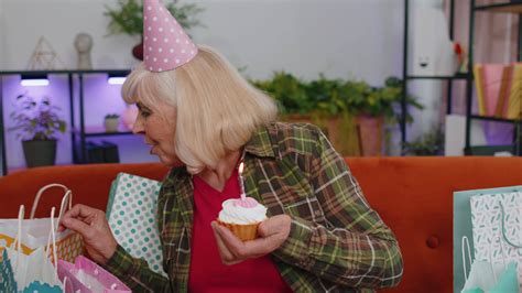 Happy senior elderly grandmother woman celebrating birthday party