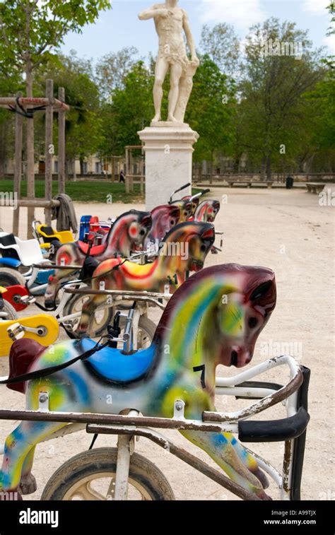 A Profile Shot Of A Line Up Of Brightly Colored Carousel Style Horses