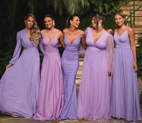 The Bridesmaids Are All Dressed In Lavender Colored Gowns And Posing