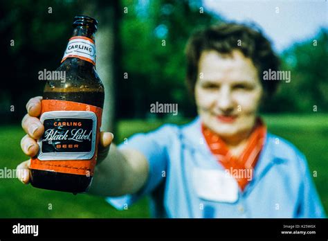 May 1958 Woman Holding A Bottle Of Carling Black Label Beer Bottle In