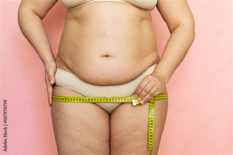 Cropped Photo Of Naked Overweight Woman Body Holding And Measuring By