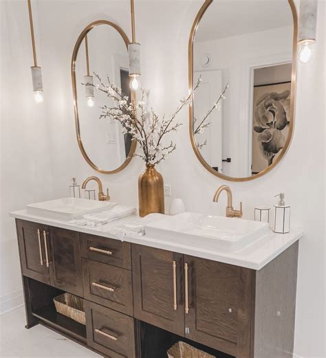 A Bathroom With Double Sinks And Two Mirrors