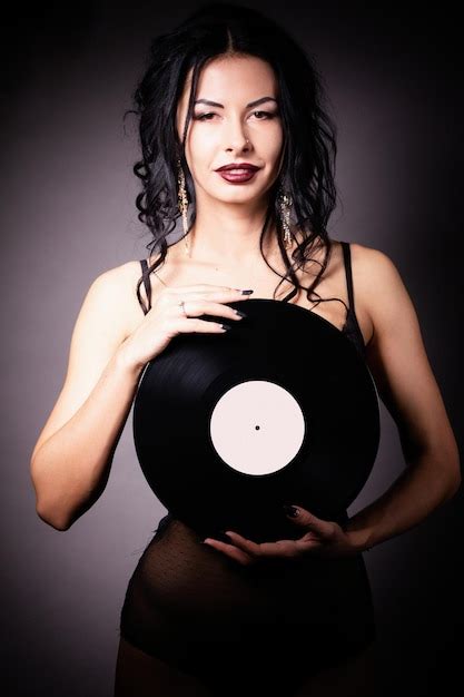 Premium Photo Vintage Photo Of A Glamorous Pinup Girl Holding A Vinyl