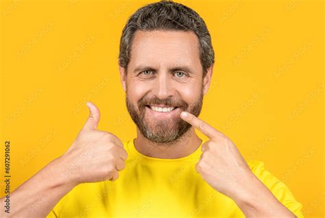 Smiling Man Pointing At Teeth Smile In Studio Thumb Up Photo Of Man