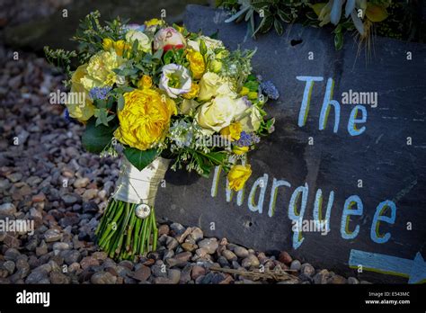 Wedding Venue Directions Written On A Slate Tile With Bridal Bouquet