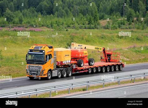 Yellow Volvo FH Semi Trailer Of Rantala Transports JLG 860SJ Telescopic