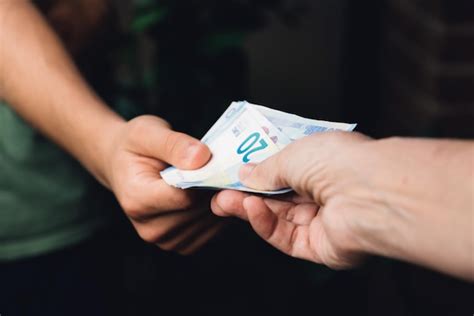 Premium Photo Cropped Image Of Hands Holding Paper Currency