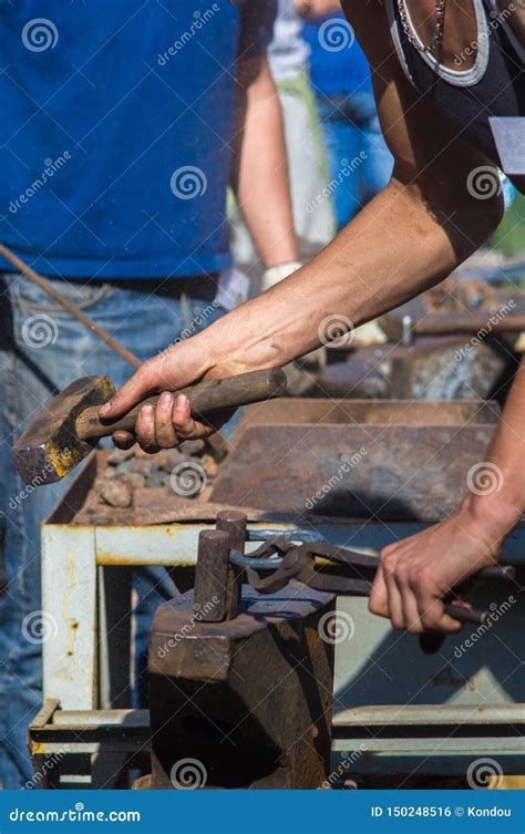 Blacksmith Performs The Forging Of Hot Glowing Metal On The Anvil Stock Photo Image Of Antique