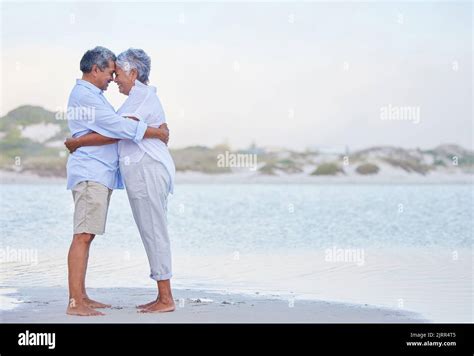 Senior Couple Retirement Beach Holiday And Travel Vacation At Sea With